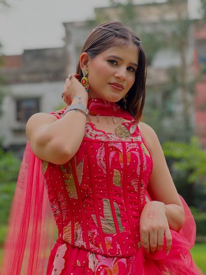 Another close-up of the pink floral gown, showing the detailed embroidery and matching dupatta.