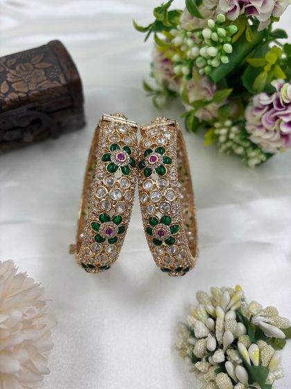 A pair of stunning openable bangles with multi-color floral Meenakari work. The combination of green, red, and white stones makes these bangles a versatile accessory.