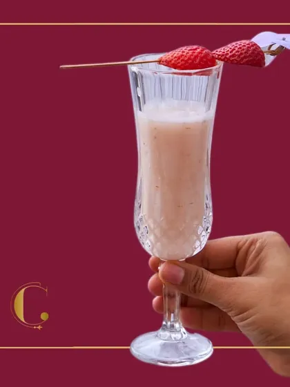 A close-up of our 'Pink Passion' drink, showcasing the fresh strawberry garnish. Every detail is crafted to create a premium beverage experience.