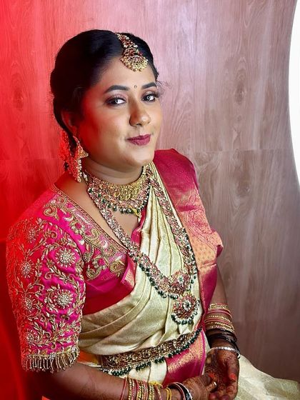A happy and radiant bride. This shot captures Nayana's smile and the beautiful details of her choker, haram, and maang tikka.
