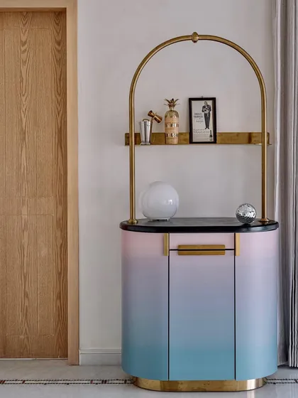 The Gradient Bar, a collaboration with Arjunvir Gujral, brings a playful yet glamorous energy to any space. Its unique gradient finish and delicate gold-arched frame create an alluring focal point for entertaining and celebration.
