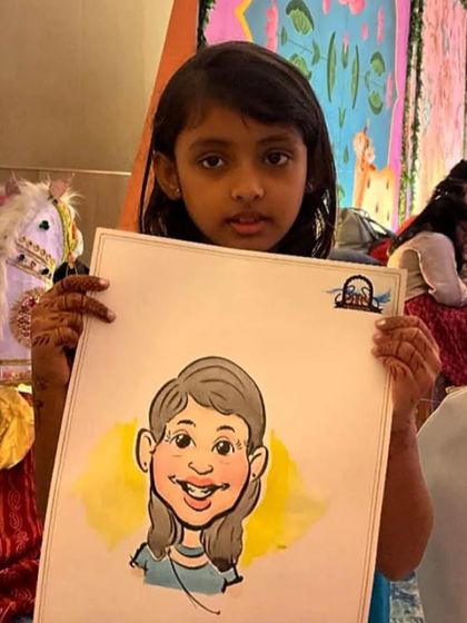 A young girl with her colorful caricature. I use watercolors to add a splash of vibrancy to the portraits.