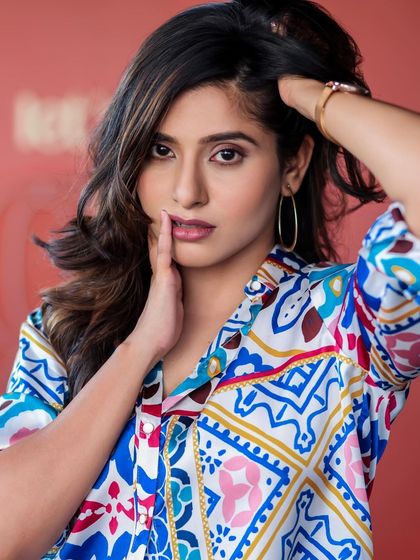 A lifestyle fashion shoot for an actress, featuring a colorful printed shirt and blue jeans. Shot in a modern cafe, these images have a bright, energetic, and youthful feel, perfect for a commercial or social media campaign.