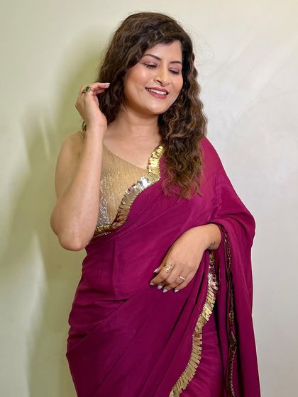 A joyful, candid moment. This image captures her beautiful smile and the easy, glamorous vibe of the whole look.