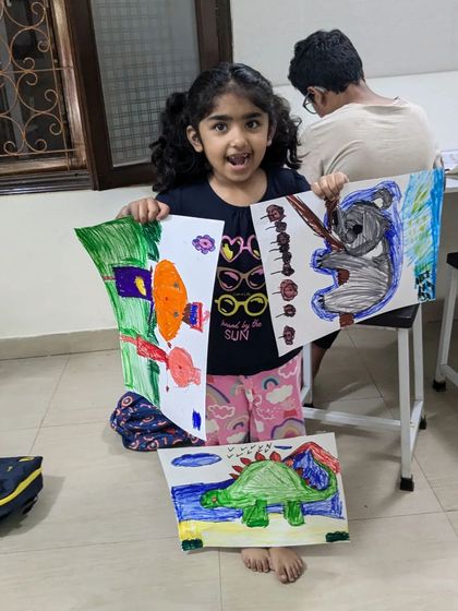 Uvika is excited to share her latest creations from class. Her collection includes a colorful koala, a dinosaur, and other fun animal drawings.