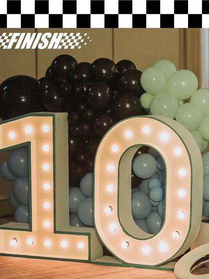 The light-up number '10' for Vihaan's F1-themed party. Marquee lights are a great way to highlight a milestone birthday and add a touch of glamour to the decor.