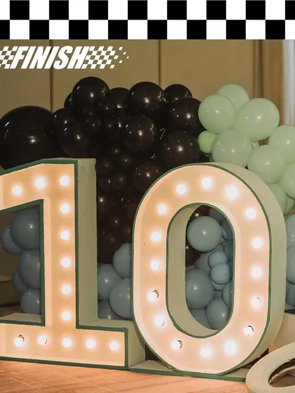 The light-up number '10' for Vihaan's F1-themed party. Marquee lights are a great way to highlight a milestone birthday and add a touch of glamour to the decor.