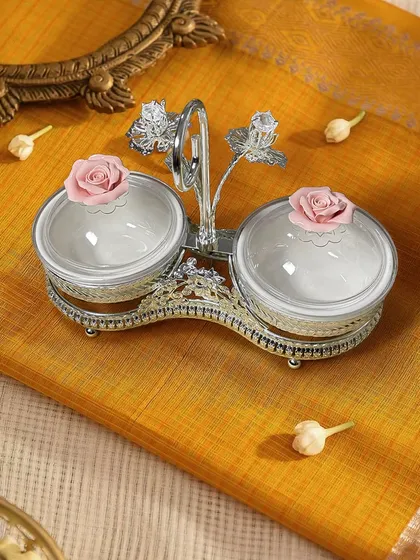 Festive gifting made graceful. This beautifully crafted dual dry fruit box features delicate pink rose knobs and a floral handle, designed to add charm to your celebrations and make every gift memorable.