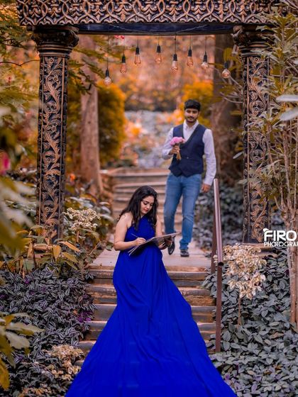 A unique angle looking up the stairs towards an ornate archway, with hanging bulbs adding a modern twist to a classic architectural element.