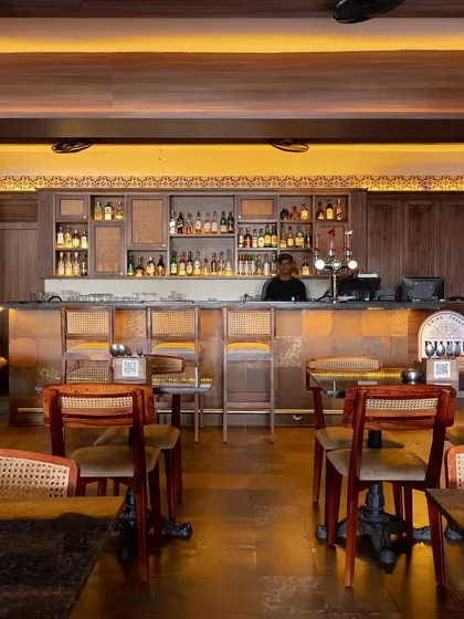 This bar area is designed for comfort and conversation. The warm wood tones, classic rattan chairs, and soft backlighting create a relaxed and timeless atmosphere where guests can feel at ease.