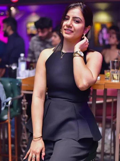 A stylish guest posing at the bar. The ambiance at my parties is always chic and photo-worthy.