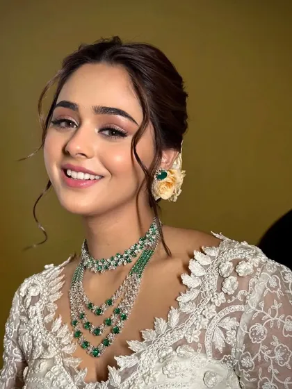 A close-up of the bride's radiant smile. The styling enhances her natural beauty, with soft makeup and elegant jewelry.
