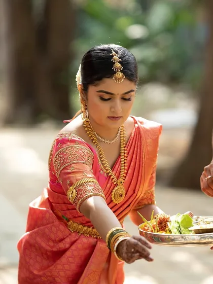 The bride participating in the wedding rituals. I ensure the makeup is set perfectly to withstand the heat and long hours of a traditional South Indian wedding.