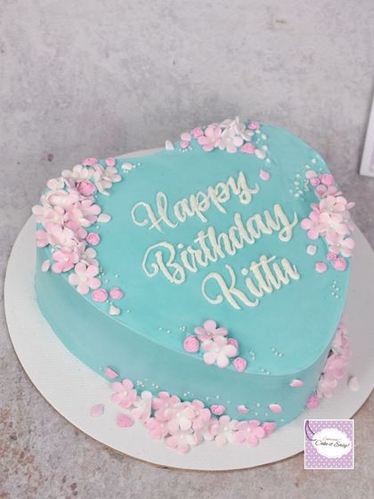 This heart-shaped cake may look simple, but it's covered in nearly 80 tiny, handmade fondant cherry blossoms. It was a labour of love, and I'm thrilled with the delicate result.