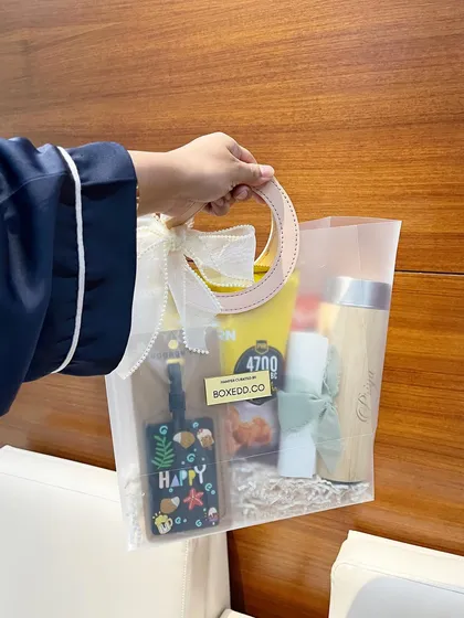 For a beach-themed bridal shower, I curated these tropical gift bags with a personalized tumbler, a luggage tag, and snacks.