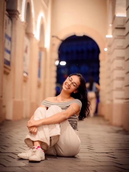 This pose, with her head tilted back in a joyful expression, is full of life. It's a great candid moment captured during the shoot.