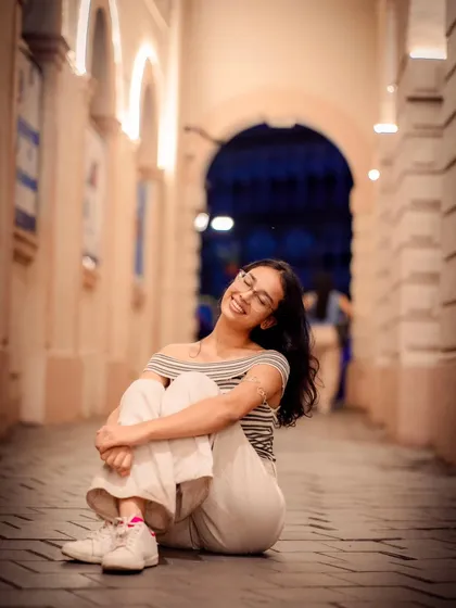 This pose, with her head tilted back in a joyful expression, is full of life. It's a great candid moment captured during the shoot.