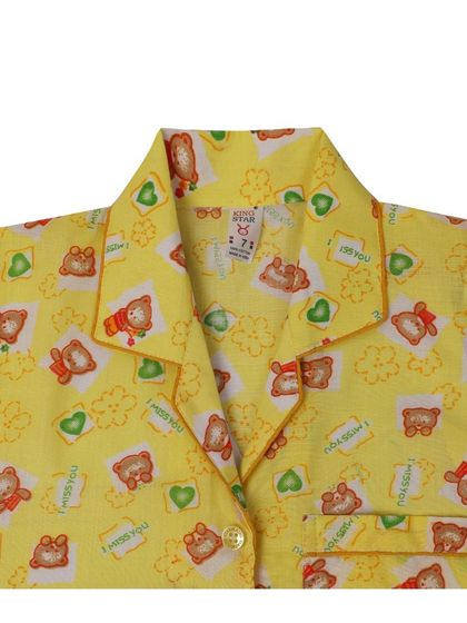 A close-up on the collar and button details of the pajama shirt.