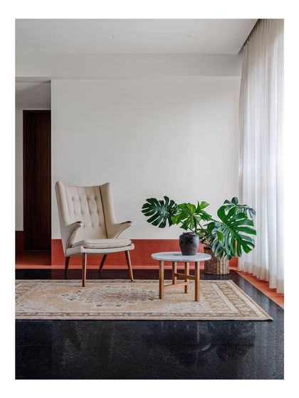 A comfortable wingback armchair and ottoman create an inviting reading nook. I design seating to be a personal refuge, a place where you can unwind in comfort and style.