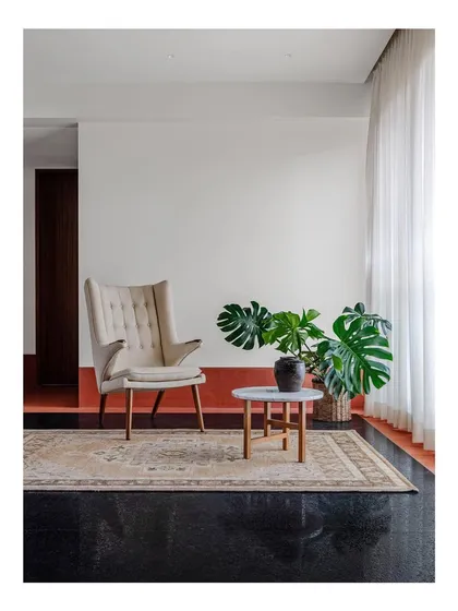 A comfortable wingback armchair and ottoman create an inviting reading nook. I design seating to be a personal refuge, a place where you can unwind in comfort and style.