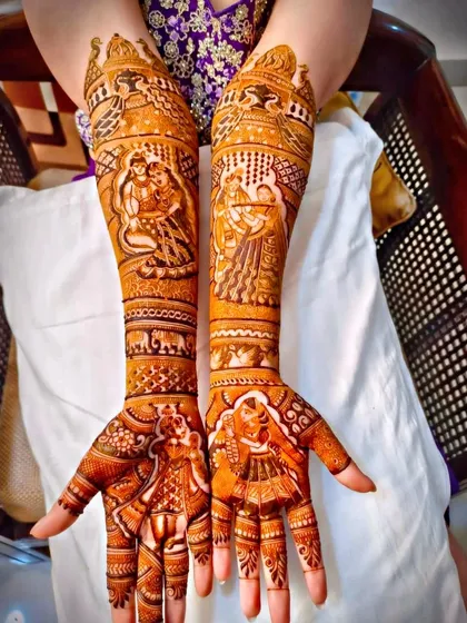 A beautiful full-arm design featuring portraits of Radha-Krishna and a wedding couple.