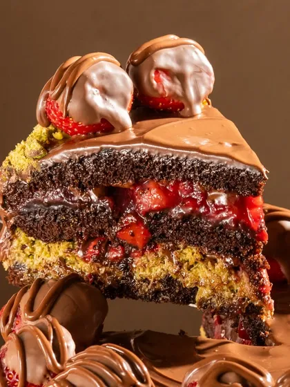 This is our Krispy Kunafa Nutella Strawberry cake. We've layered crispy, golden kataifi and earthy pistachio with our classic chocolate sponge and strawberry compote for a textural masterpiece.