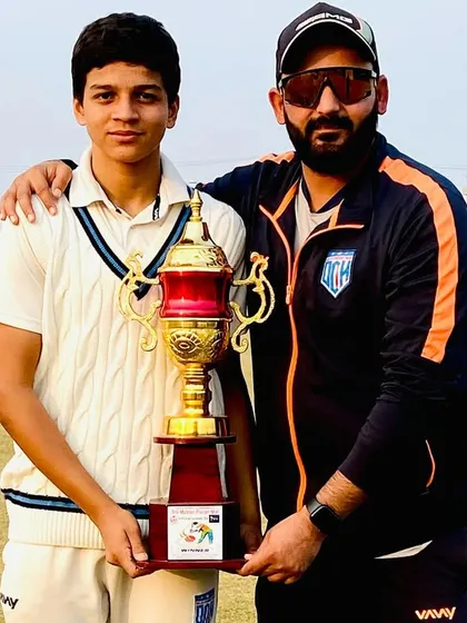 With the Man of the Series, holding the main trophy. A proud moment for the coach.