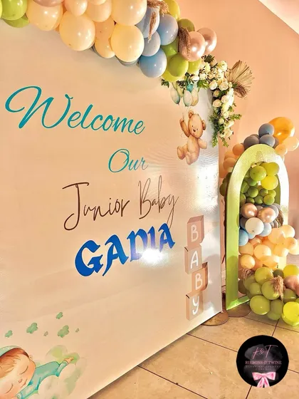 Detail shot of the custom vinyl lettering on the backdrop, along with wooden 'BABY' blocks and a floating teddy bear graphic.