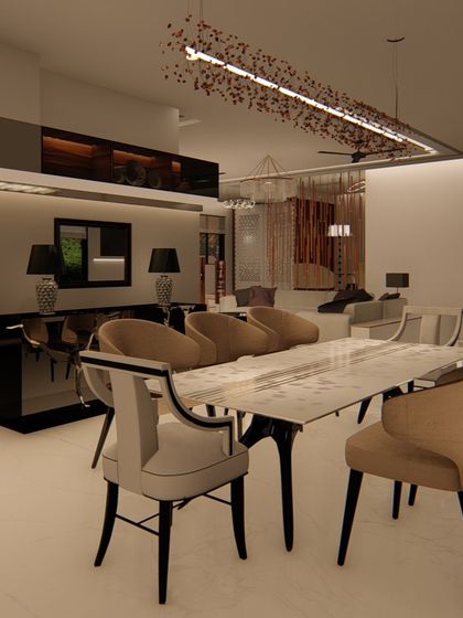 This formal dining area features a marble-topped table and elegant, high-backed chairs. A modern, artistic chandelier hangs above, and a sleek black console table sits against the wall for serving and display.