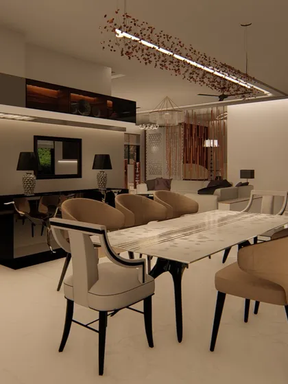 This formal dining area features a marble-topped table and elegant, high-backed chairs. A modern, artistic chandelier hangs above, and a sleek black console table sits against the wall for serving and display.