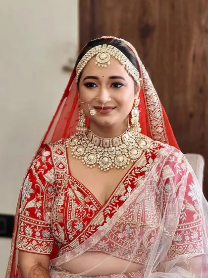 A happy bride, looking fresh and radiant. The makeup is designed to enhance her natural features, creating a look of timeless beauty.