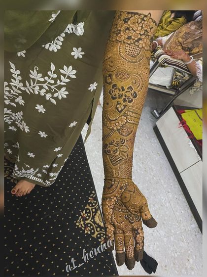 A single-arm view of a detailed bridal design, showing the precision in every line and curve.