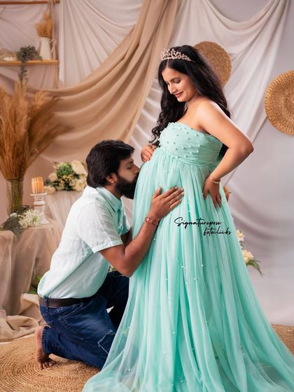 A classic pose of pure love and anticipation, as the father-to-be kisses the baby bump.