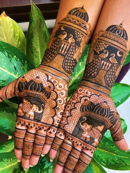 This design is all about grandeur. The combination of majestic elephants on the palms and regal peacocks on the arms creates a truly breathtaking bridal look.