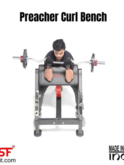 A user at the top of a preacher curl, showing the peak contraction this bench facilitates.