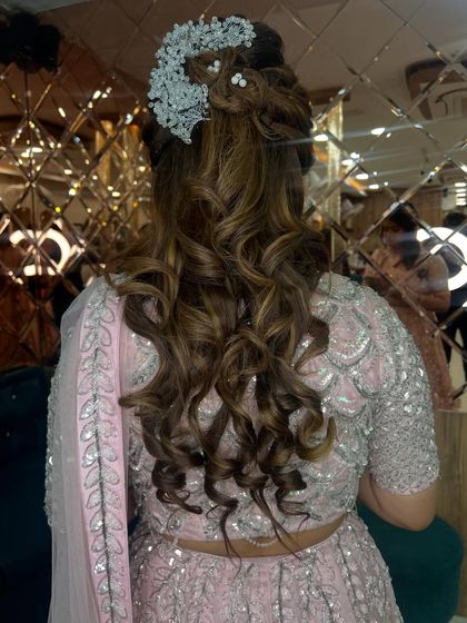 A clear view of the back of the updo, showcasing the intricate curls and the placement of the stunning accessory.