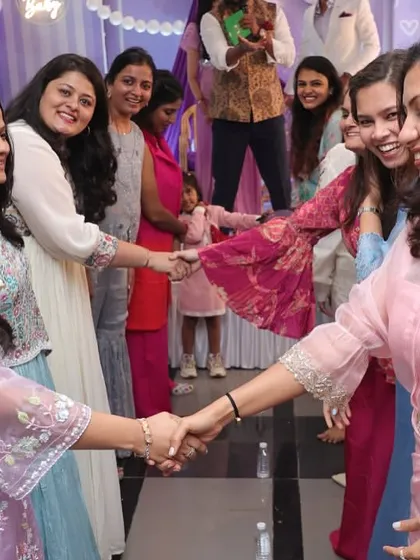 A friendly handshake during one of the team games. These activities are great for fostering a sense of community and shared joy among guests.