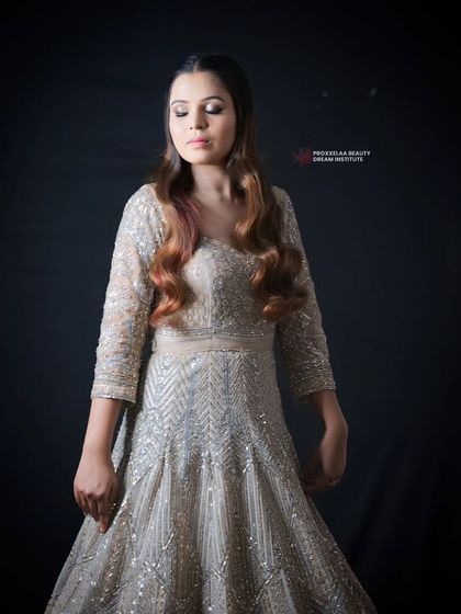 A full view of the elegant party gown. The soft waves in the hair complement the flowing silhouette of the dress, creating a cohesive and graceful look.