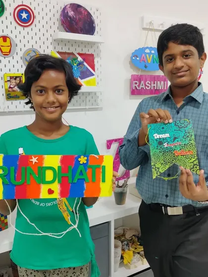 Cousins spending quality vacation time at our studio, creating a personalized nameplate and a decorative banner for their rooms.