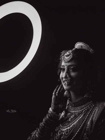 A beautiful black and white portrait where the ring light creates a halo effect. The bride's expression is soft and thoughtful, resulting in a timeless and artistic photograph. (Duplicate of 112)