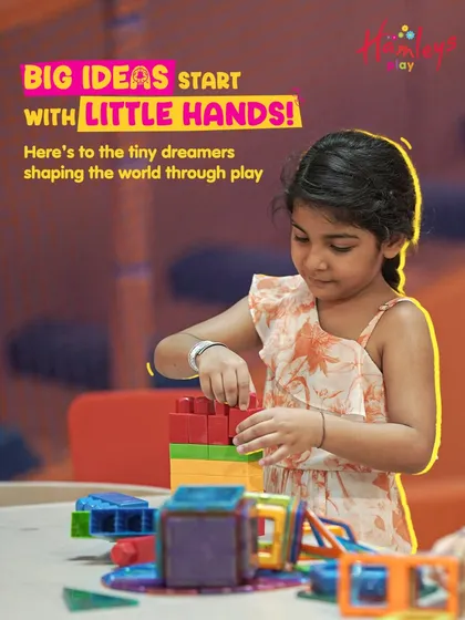 Big ideas start with little hands! Here's to the tiny dreamers shaping the world through play. A young girl builds with colorful magnetic tiles, her imagination running free.