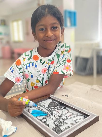 Another young participant enjoying our glass painting session, creating a beautiful piece of art to hang in a window.