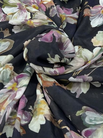 Soft as a petal and light as air, this printed muslin with a timeless floral charm on a black base is perfect for comfortable yet stylish outfits.