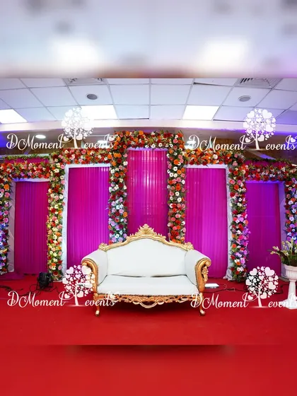 I believe every milestone deserves elegance. This 50th golden anniversary stage is framed with lush, real flower garlands against vibrant pink drapery, creating a sophisticated and timeless backdrop for celebrating a lifetime of love.