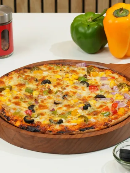 A classic vegetable pizza, shot bright and clean for a delivery menu. We ensure all the toppings are visible and the cheese looks perfectly melted to attract customers on platforms like Zomato and Swiggy.