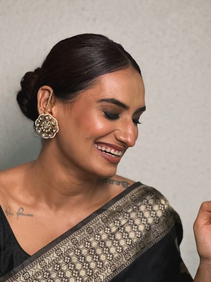 A happy, candid shot of the finished look. The makeup is flawless, and her smile shows how confident and beautiful she feels in this classic, celebrity-inspired glam.