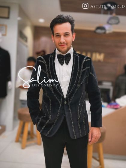 A client wearing a black velvet tuxedo with a geometric silver beaded pattern. This design is perfect for a modern groom or for any formal evening event.