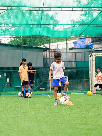 The foundation of a great player is solid fundamentals. Here, our junior athletes are practicing ball control, an essential skill for any aspiring footballer.