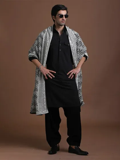 A Pathani suit, but this time with added charm. The black base is contrasted with a beautifully patterned stole, offering a fresh and stylish take on a classic ensemble.