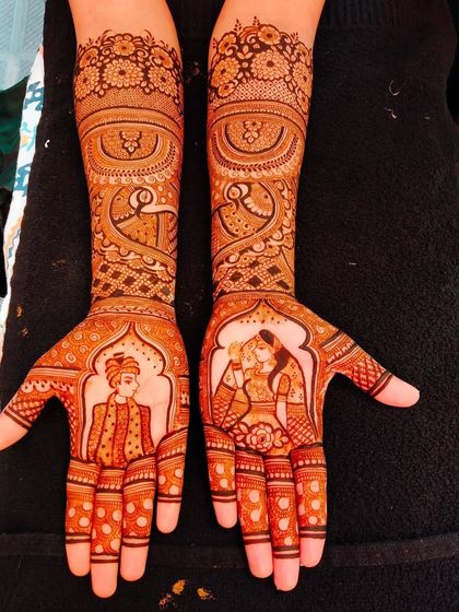 A classic couple portrait within an arched frame, surrounded by peacock and floral patterns.